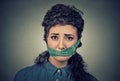 Diet restriction and stress concept. Frustrated woman with measuring tape around her mouth