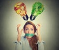 Diet restriction stress concept. Frustrated woman with measuring tape around mouth