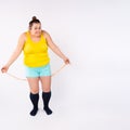Diet restriction and stress concept. Portrait of young frustrated caucasian woman with beige measuring tape around her