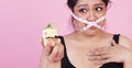 Diet restricts, weight loss, eating disorder concept. overweight fat woman with measure tape cover her mouth while holding