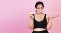 Diet restricts, weight loss, eating disorder concept. Obese overweight fat woman with measure tape cover her mouth while holding