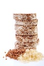 Diet rice cakes pile with buckwheat and rice grains isolated on white background Royalty Free Stock Photo