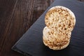 Diet rice cakes pile on dark piece of board on the wooden table, selective focus.