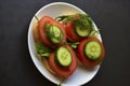 Diet sandwiches with greens, cucumber and tomato on a white plate