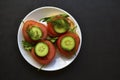 Diet sandwiches with greens, cucumber and tomato on a white plate