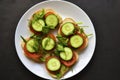 Diet sandwiches with greens, cucumber and tomato on a white plate