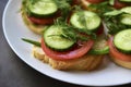 Diet sandwiches with greens, cucumber and tomato on a white plate