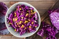 Diet snack. Red cabbage salad with corn grains in a plate on a wooden table. Vegetarian food. Top view. Close-up Royalty Free Stock Photo