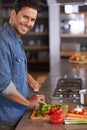 The diet starts today. a handsome young man chopping vegetables on the kitchen counter. Royalty Free Stock Photo