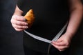 Obese woman with fattening food and measure tape Royalty Free Stock Photo