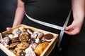 Obese woman with fattening food and measure tape Royalty Free Stock Photo