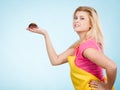 Woman holding chocolate cupcake about to bite Royalty Free Stock Photo