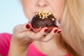 Woman holding chocolate cupcake about to bite Royalty Free Stock Photo