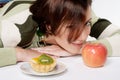 Diet temptation - cake against apple Royalty Free Stock Photo