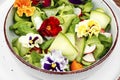 Colorful vegetable salad with edible flowers