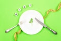 Diet, weigh loss, healthy eating, fitness concept. Small portion of food on big plate. Small green salad leaf on white plate with Royalty Free Stock Photo