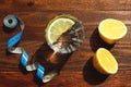 Diet and weight loss concept. A glass of water with lemon and a measuring tape, metric rules on a wooden background