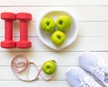 Diet and weight loss for healthy care with fitness equipment,fresh water and fruit healthy,apple green apple, on white wooden bac Royalty Free Stock Photo