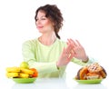 Diet. Woman choosing between Fruits and Sweets Royalty Free Stock Photo