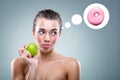 ÃÂ The Diet! Woman eating an apple , but he thinks a donut Royalty Free Stock Photo