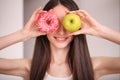 Diet. Woman Measuring Body Weight On Weighing Scale Holding Donut and apple. Sweets Are Unhealthy Junk Food. Dieting, Healthy Eat Royalty Free Stock Photo