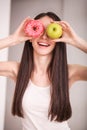 Diet. Woman Measuring Body Weight On Weighing Scale Holding Donut and apple. Sweets Are Unhealthy Junk Food. Dieting, Healthy Eat Royalty Free Stock Photo