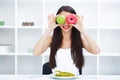 Diet. Woman Measuring Body Weight On Weighing Scale Holding Donut and apple. Sweets Are Unhealthy Junk Food. Dieting, Healthy Eat Royalty Free Stock Photo