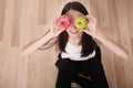 Diet. Woman Measuring Body Weight On Weighing Scale Holding Donut and apple. Sweets Are Unhealthy Junk Food. Dieting, Healthy Eat Royalty Free Stock Photo