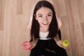 Diet. Woman Measuring Body Weight On Weighing Scale Holding Donut and apple. Sweets Are Unhealthy Junk Food. Dieting, Healthy Eat Royalty Free Stock Photo