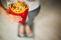 Diet. Woman Measuring Body Weight On Weighing Scale Holding Unhealthy Junk Food. Weight Loss. Obesity. Top View Royalty Free Stock Photo