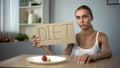 Diet word written by depressed anorexic girl, starving body, eating disorder Royalty Free Stock Photo