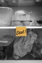 Diet written on a sticky note stuck on a fridge shelf with food Royalty Free Stock Photo