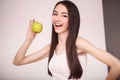 Diet. The young beautiful girl who cares for her figure, making healthy food choices, fresh fruit. The concept of healthy eating Royalty Free Stock Photo