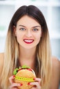 Diet. Young beautiful woman eating burger, It`s junk and unhealt