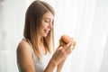 Diet. Young woman with duct tape over her mouth, preventing her to eat junk food. Healthy eating concept Royalty Free Stock Photo