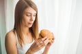 Diet. Young woman with duct tape over her mouth, preventing her to eat junk food. Healthy eating concept Royalty Free Stock Photo