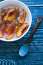 Dietary breakfast with granola, homemade yoghurt, peach and cream on a blue background. Royalty Free Stock Photo