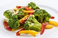 Dietary broccoli with vegetables and peanuts. On a white plate