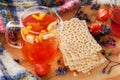 Dietary crackers, wild forest berries, physalis and fruit tea with lemon on a wooden table