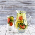 Dietary detox drink with lemon juice, red strawberry, cucumber and mint leaves in clear water with ice. Royalty Free Stock Photo