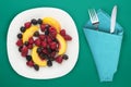 Dietary, healthy food. blackberry, raspberry, nectarine on a white plate on a plate. Vegetarian food on a background top view