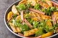 Dietary light salad of grilled chicken, rhubarb, lettuce, onions and oranges close-up on a plate. horizontal Royalty Free Stock Photo