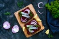 Dietary sandwiches with beets, slices of salted herring and red onion on rye bread Royalty Free Stock Photo