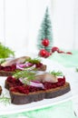 Dietary sandwiches with herring, boiled beets, red onion on rye bread on a white wooden background. Royalty Free Stock Photo