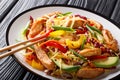 Dietary spicy Asian coleslaw salad with chicken, avocado and vegetables close-up on a plate. horizontal