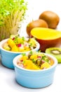 Dietetic salad in the pot with kiwi and mango isolated on white