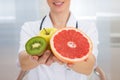 Dietician holding fresh sliced fruits Royalty Free Stock Photo