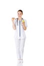 Dietician holding sweet doughnut and fresh healthy green apple.