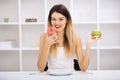 Dieting concept, beautiful young woman choosing between healthy Royalty Free Stock Photo