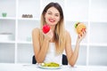 Dieting concept, beautiful young woman choosing between healthy Royalty Free Stock Photo